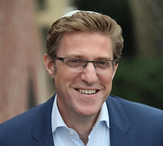 Smiling man in business suit outdoors, professional portrait for Mekomos SEO branding images.