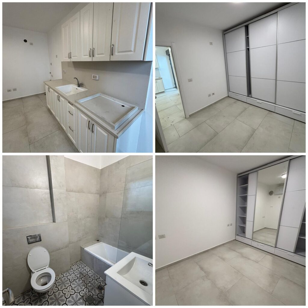 Modern white kitchen and bathroom with minimalist design, large wardrobes, and neutral floor tiles.