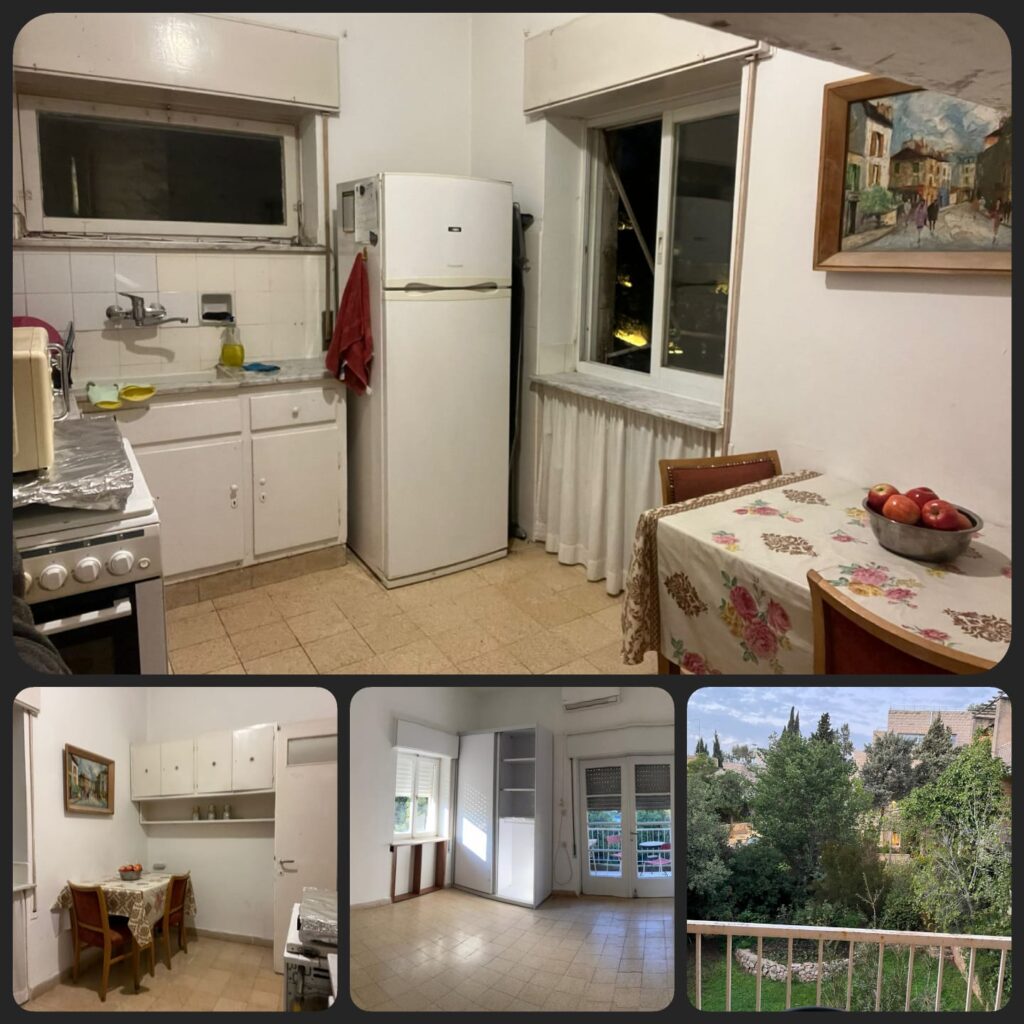 Bright kitchen with white cabinets and refrigerator, adjacent to dining area with floral tablecloth and bowl of apples.