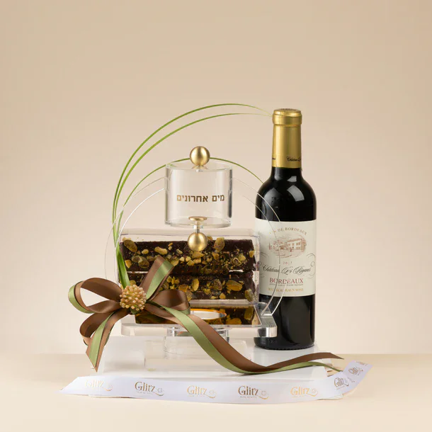 Beautiful gift arrangement featuring wine, a decorative jar, and ribbon for celebrations.