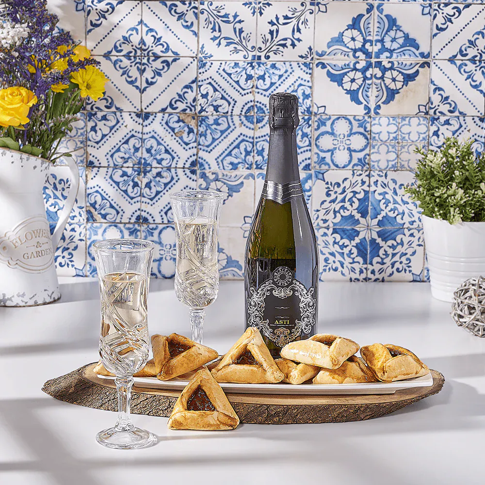 Elegant champagne and pastry snack setup with blue patterned tiles, fresh flowers, and sparkling wine.