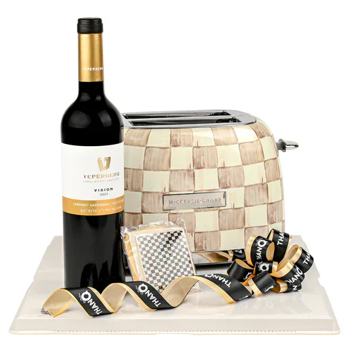 Wine bottle with gift box, corkscrew, and ribbon for celebration.