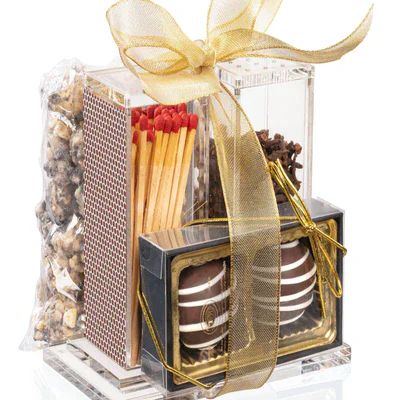 Luxurious chocolate and candy gift set with gold ribbon and assorted treats.