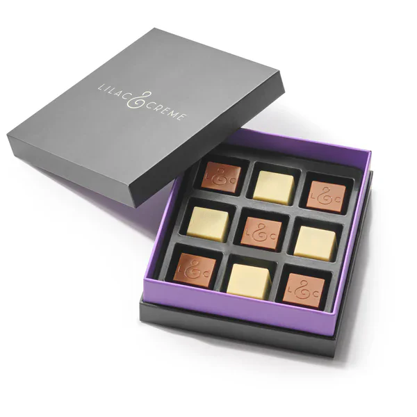 Assorted lilac and creme chocolates in elegant box.