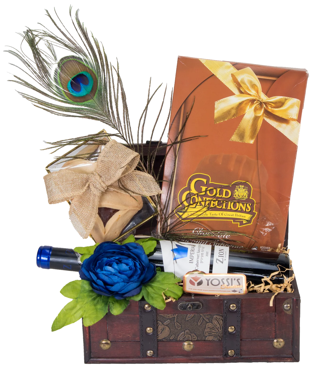 Peacock feather, wine bottle, chocolate, and gift box in a wooden chest.