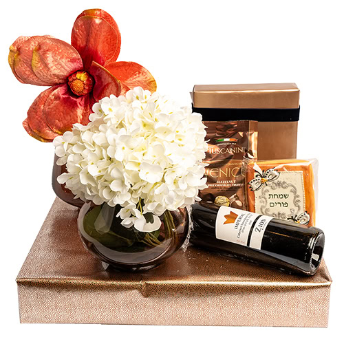 Beautiful floral arrangement with white hydrangeas and pink orchids, accompanied by chocolates and a.