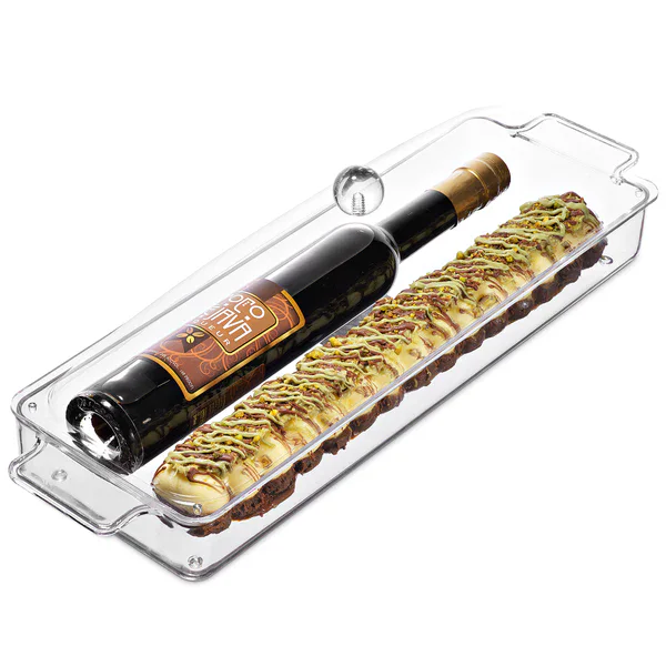 Miniature sushi roll with soy sauce bottle in clear plastic tray, perfect for appetizer or snack.