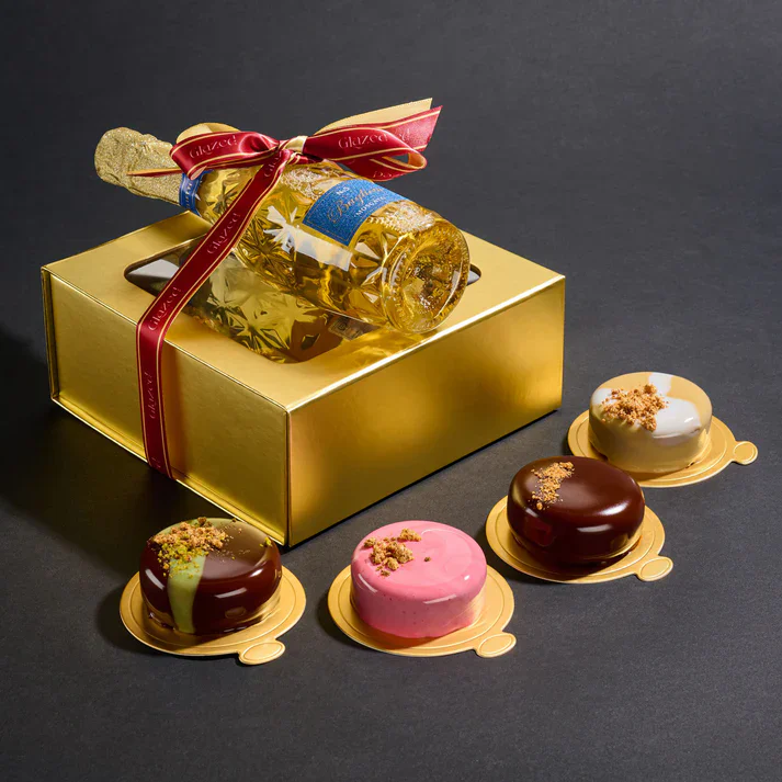 Elegant gift set featuring chocolates and a mini champagne bottle for celebrations.