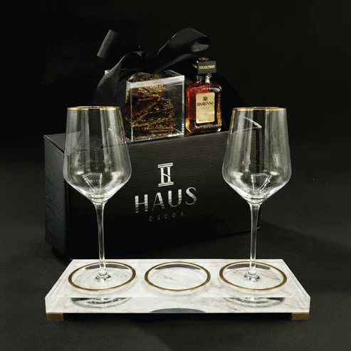 Luxury whiskey gift set with glasses, whiskey bottle, and accessories in black box.