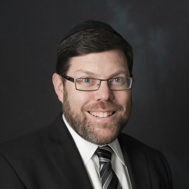 Celebrant smiling at Tomchei Shabbos Shavuos 2026 event in Suffern, NY, celebrating community and Je.